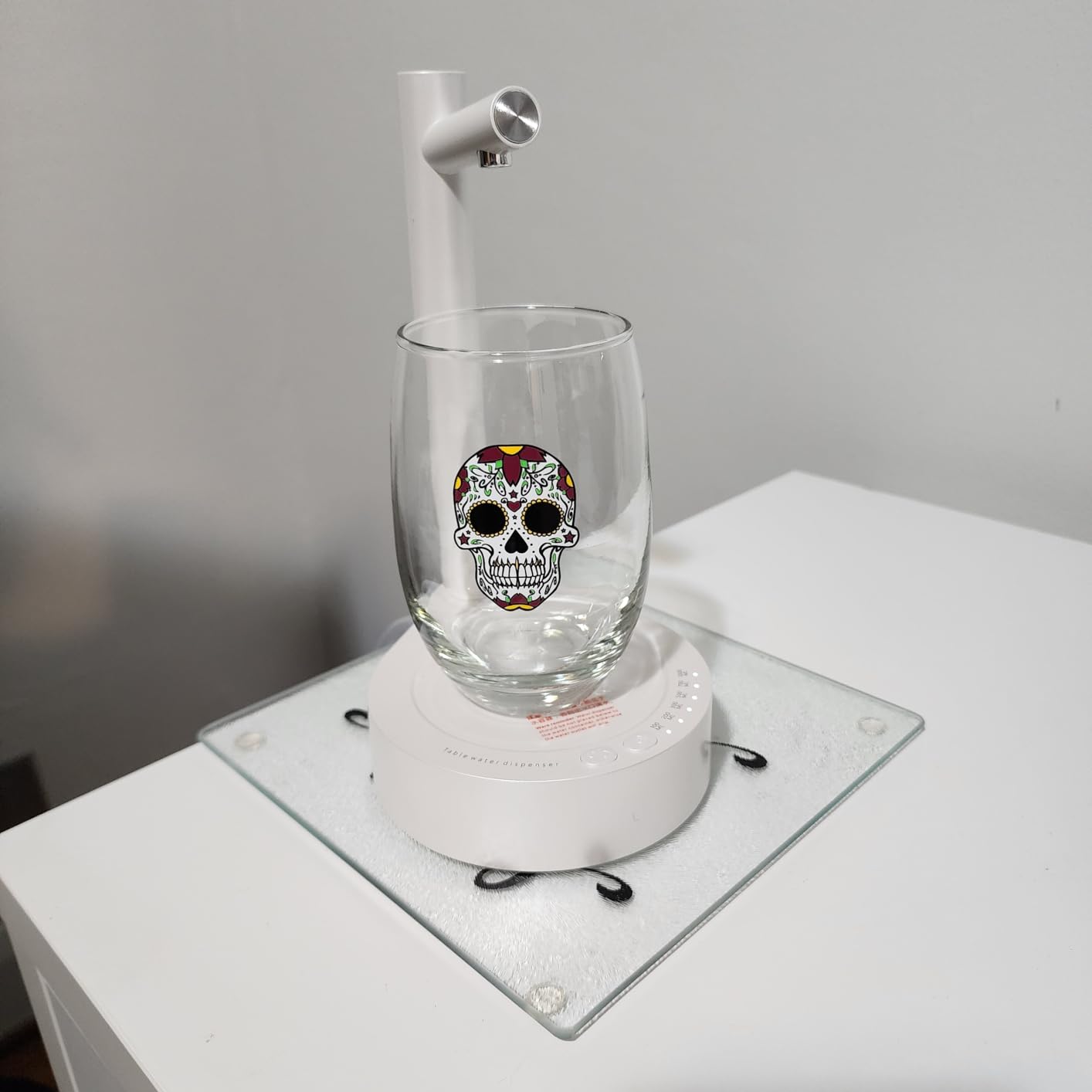 Water flowing from a smart table water dispenser to a transparent cup