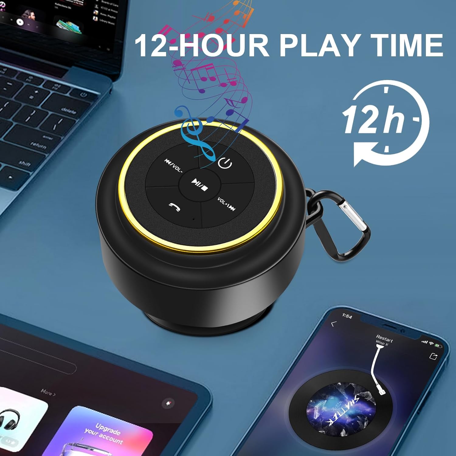 Black and gold mini Bluetooth speaker placed on a desk beside a laptop and smartphone, with a 12-hour play time graphic and music notes illustrated around it