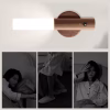 Wooden motion sensor night light mounted on wall above three panels showing a person sleeping, walking, and waking up at night