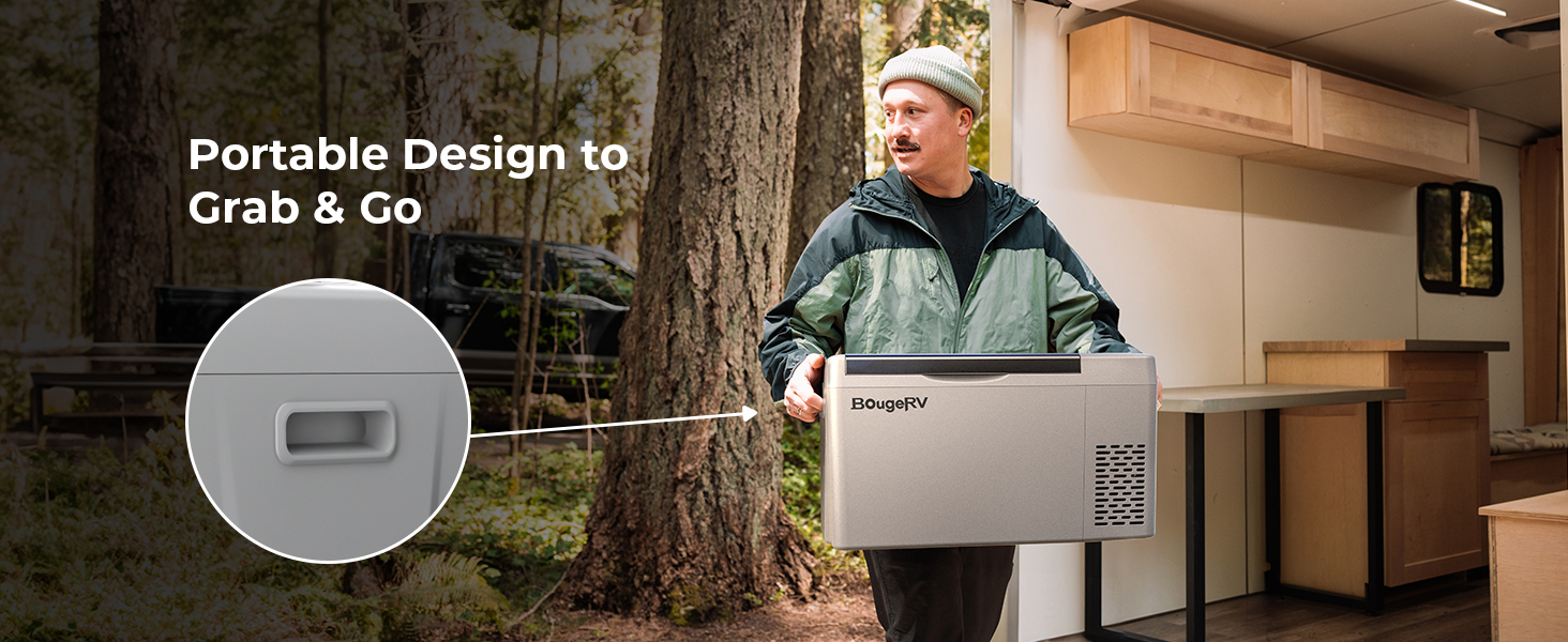 Man carrying a portable fridge by its built-in side handle outside an RV in a forest campsite, showcasing its lightweight grab-and-go design.
